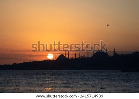 View of Istanbul's historical peninsula at sunset. View of the Sultanahmet Mosque located on the historical peninsula in silhouette. Royalty-Free Stock Photo #2415714939
