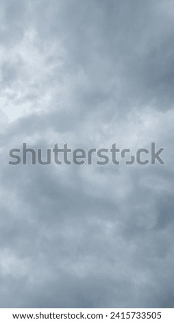 overcast clouds view from below. Grey sky foreshadows rain. Royalty-Free Stock Photo #2415733505