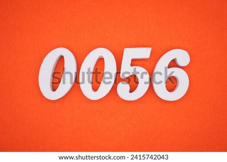 Orange felt is the background. The numbers 0056 are made from white painted wood.