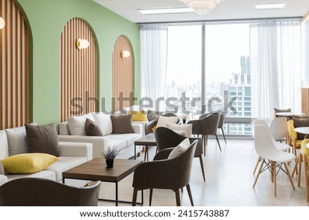 Empty stylish and modern office interior with skyscrapers view decorated with table, chair, botany decoration, elegant accessory. Living room. Modern interior. Creative design. Day light. Ornamented. Royalty-Free Stock Photo #2415743887