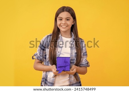teen girl with present. teen girl holding present box with excitement at birthday party. teen girl holding a present. teen girl show present on a special occasion. exchange gifts