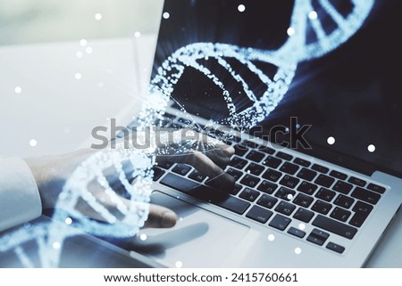 Double exposure of creative DNA hologram and hands typing on laptop on background. Bio Engineering and DNA Research concept