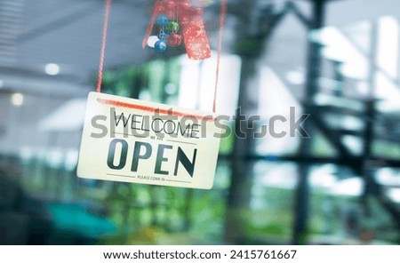 A turning open sign board on glass door in modern cafe coffee shop ready to service, cafe restaurant, retail store, small business owner, food and drink concept