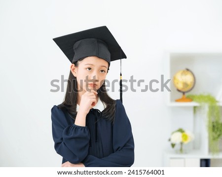 Thinking Asian little girl dressed as a doctor.