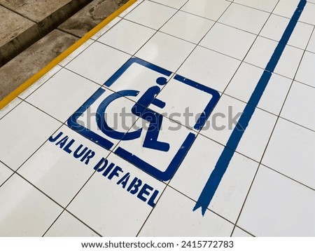 Lane for people with disability or difabel sign on the floor