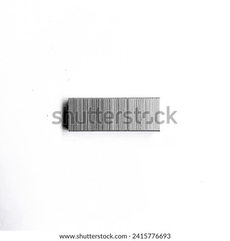 The contents of the medium-sized staples are silver, made of iron, isolated on a white background
