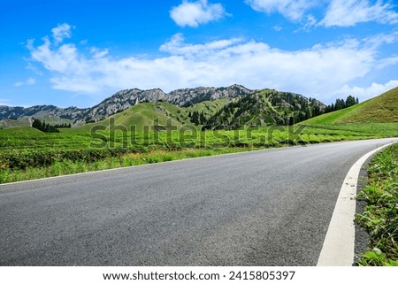 Country road and green tea garden with mountain nature landscape under the blue sky