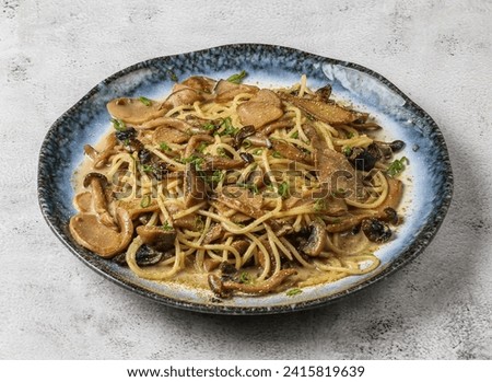 wild mushroom pasta served in dish isolated on grey background top view of singapore food Royalty-Free Stock Photo #2415819639