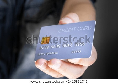 Man holding  credit cards and he use credit card to pay and spend Payment for goods via credit card. Finance and banking concept.