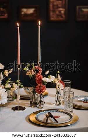 Wedding set up, reception closeup. Festive dinner table decorated with flower and greenery, candles. Birthday celebration in restaurant. Serving, setting table. Plate, silverware cutlery, glasses. Royalty-Free Stock Photo #2415832619