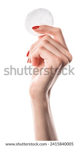 Woman holding cotton pads isolated on white background. Cotton pads in female hand with red nails. High quality photo
