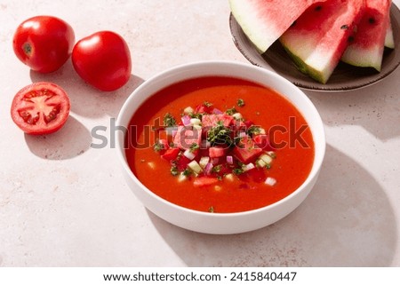 Spanish tomato and watermelon gazpacho cold soup styled and decorated in white plate Royalty-Free Stock Photo #2415840447