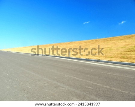 Autumn slope scenery leading from the Edogawa riverbed to the bank cycling road Royalty-Free Stock Photo #2415841997