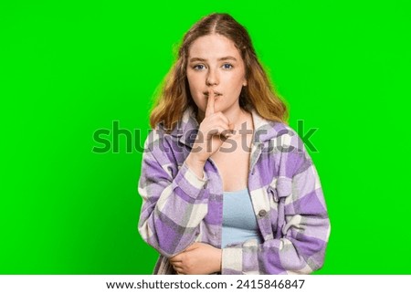 Shh be quiet please. Young woman presses index finger to lips makes silence gesture sign do not tells secret, stop talk gossip, confidential privacy. Redhead girl isolated on chroma key background