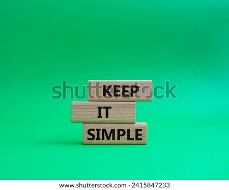 Keep it Simple symbol. Concept words Keep it Simple on wooden blocks. Beautiful green background. Business and Keep it Simple concept. Copy space. Royalty-Free Stock Photo #2415847233