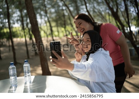 happy asian women taking picture together after exercise