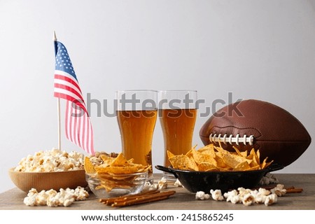 Beer with snacks, a rugby ball and an American flag Royalty-Free Stock Photo #2415865245