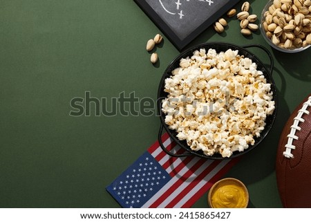 Blackboard with rugby strategy, bowl of popcorn and flag