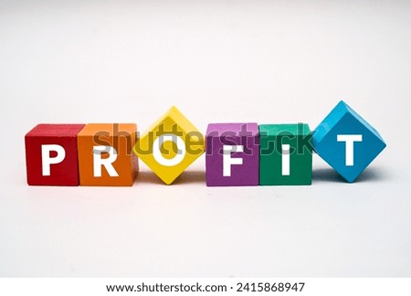 A coloured wooden block with word “PROFIT” on it