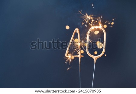 40 years celebration festive background made with Bengal fires in the form of number Forty. Royalty-Free Stock Photo #2415870935