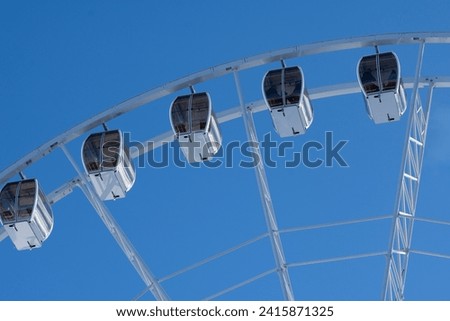 Ferris Wheel in publik park. Winter holidays in the Carpathians. Attraction in the recreational park in Bukovel.  Royalty-Free Stock Photo #2415871325
