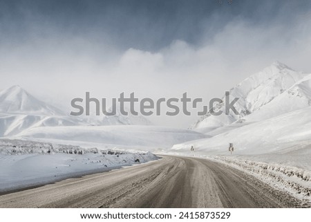 snow winter mountain road. blizzard. Royalty-Free Stock Photo #2415873529