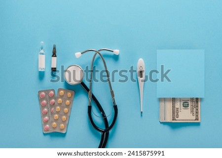 Concept of health and business showing currency notes, thermometer, stethoscope, pills and ampoules