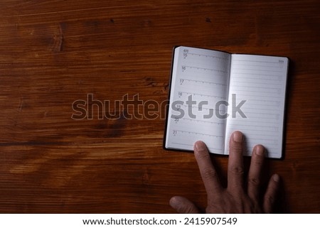 The hand of the person who opens the notebook