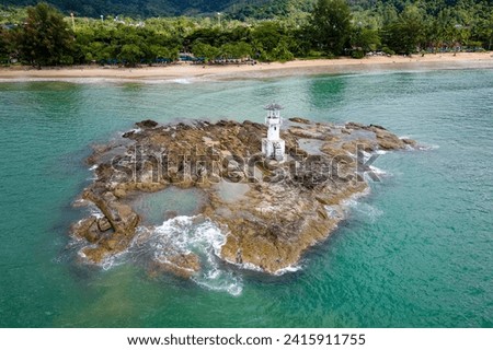 Aerial view of a small lighthouse off the tropical Nangthong Beach in Khao Lak, Thailand