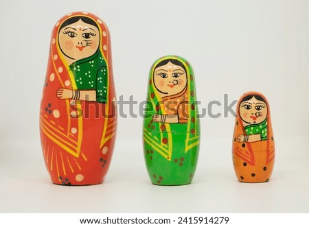 Traditional Indian Wooden toy set hand painted showcasing three women in saree decorative showpieces Royalty-Free Stock Photo #2415914279