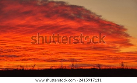 Dramatic colorful sunset on a cloudy sky during the cold season.