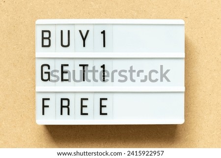 Lightbox with word buy 1 get 1 free on wood background