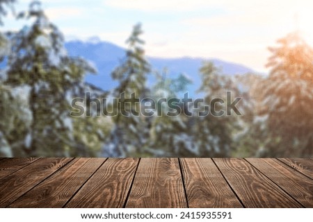 The empty wooden table top with background of winter forest