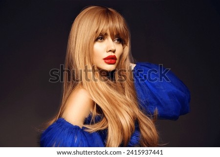 Beautiful perfect long hairstyle. Beauty makeup. Girl model portrait with red lips and wavy hair style isolated on black studio background. Profile face. Royalty-Free Stock Photo #2415937441