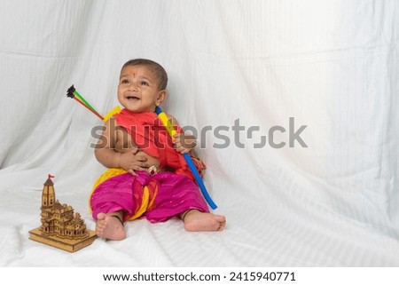 Indian baby dressed as Lord Rama Shri Ram Ayodhya bow arrow temple infant child fancy dress hindu love smile festival navmi costume dhoti history story dushehra navratri diwali happiness sstkbabies Royalty-Free Stock Photo #2415940771