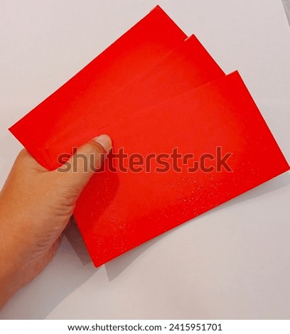 Angpao or THR envelope. Angpao is a gift in an envelope containing a sum of money to celebrate Chinese New Year.