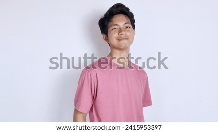 Handsome Asian man with a thin smile poses coolly on a white background