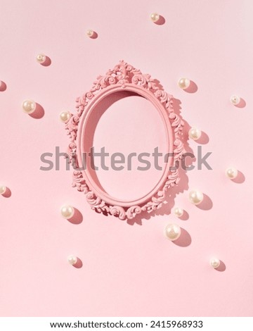 Oval vintage picture frame, empty, pearl beads scattered on pastel pink background, creative copy space, place for presentation, text, greetings, feminine, elegant minimalist style.