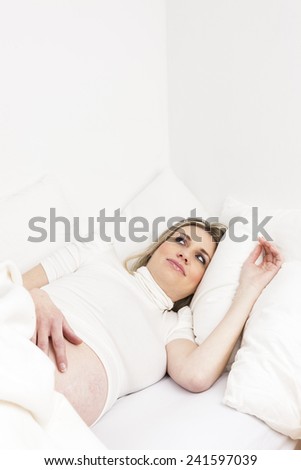 pregnant woman resting in bed