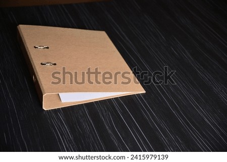Brown folder on a black office table
