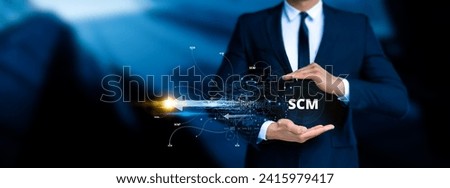 Supply Chain Management (SCM). the end-to-end management of goods and services flow within a business. Businessman touching the scm icon on digital screen  Royalty-Free Stock Photo #2415979417