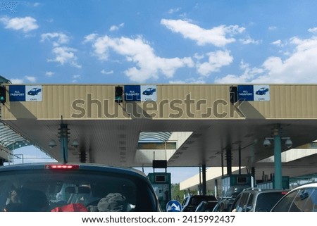 Customs checkpoint for cars. Passport verification and document inspection at border crossing. European border crossing sign with green traffic light. 