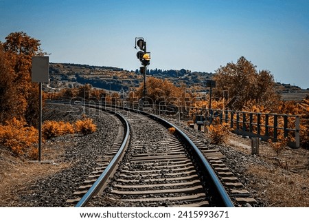a railway track runs through the arid hills of eastern Sicily