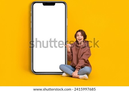 Full size photo of surprised girl direct finger phone display shocked unexpected new update apple ios isolated on yellow color background Royalty-Free Stock Photo #2415997685