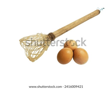 The egg beater is made of string with a wooden handle, isolated on a white background