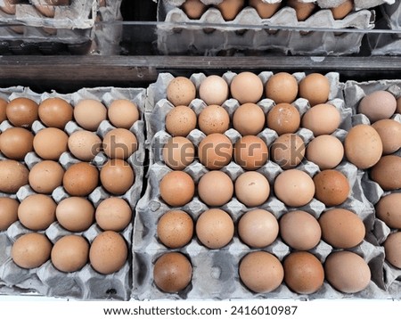 A close up picture of raw chicken eggs in egg box.