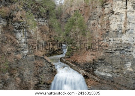 Afternoon winter photo of Lucifer Falls waterfall in Robert H. Treman State Park near Ithaca NY, Tompkins County New York.  (01-13-2024)	