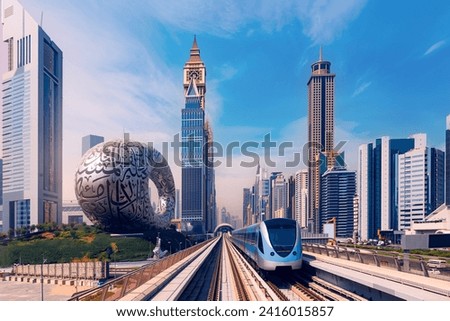 Famous tourist landmark Dubai, cityscape with skyscrapers. Modern metro railway with sun light. Luxury Business and financial district of city UAE. Royalty-Free Stock Photo #2416015857