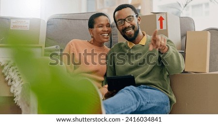 African couple, pointing and new home with tablet, boxes and thinking with discussion, decision and choice. Black woman, man and floor for planning, moving or chat for real estate, property or house