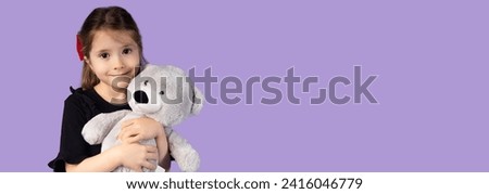 The picture used for banners or advertisements with a very beautiful blonde girl with wavy hair and a very beautiful and attractive smile holding a teddy bear as her favorite toy.